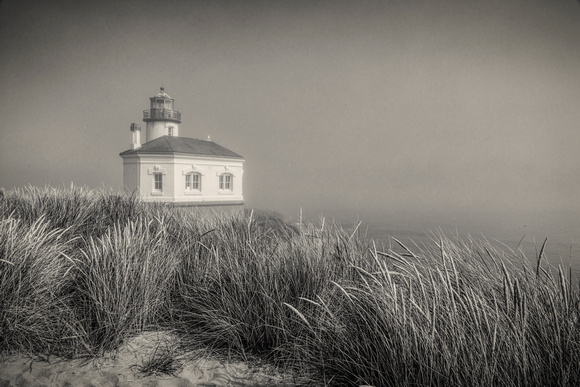Coquille Point Lighthouse in lifting fog.